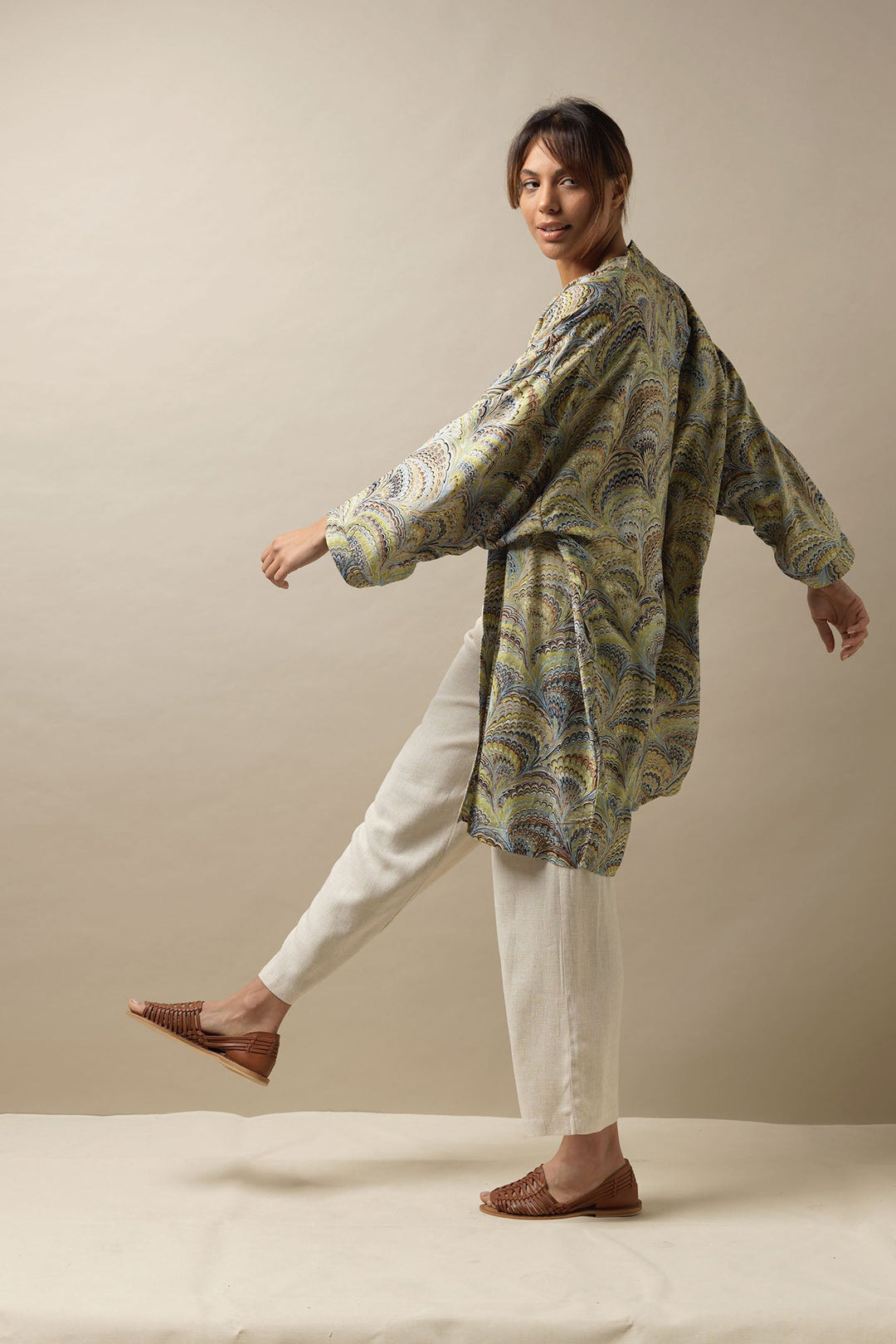 One Hundred Stars marbled green blue and brown mid length kimono jacket. These cover ups can be worn with linen trousers and woven sandals to create a must have look this summer. 
