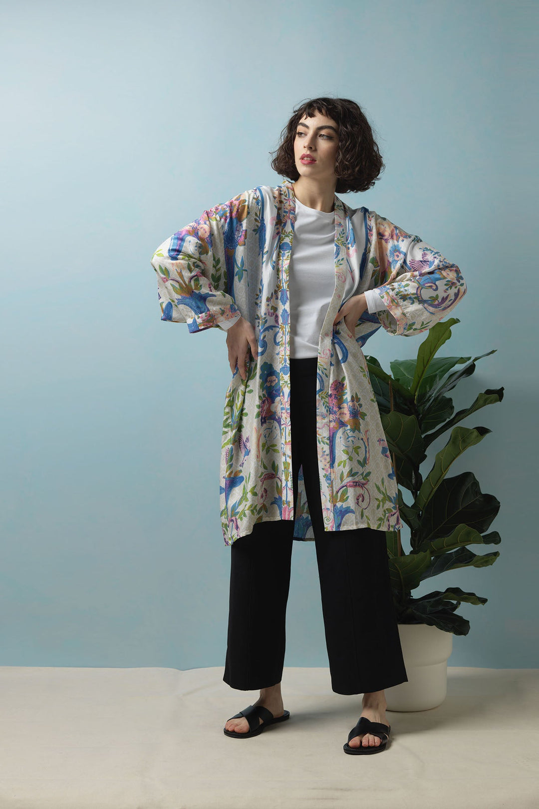 The Opulent Pastel print features a blue and beige intricate pattern with peach and pink flowers. Perfect for wearing with a classic white t-shirt, black trousers and sandals this summer season.  