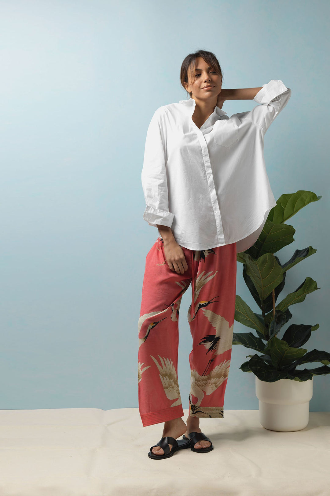 The One Hundred Stars Stork Crane Lipstick Pink Crepe Lounge Pants feature black and white cranes on a vivid pink background. Storks and cranes have been a major art deco trend.