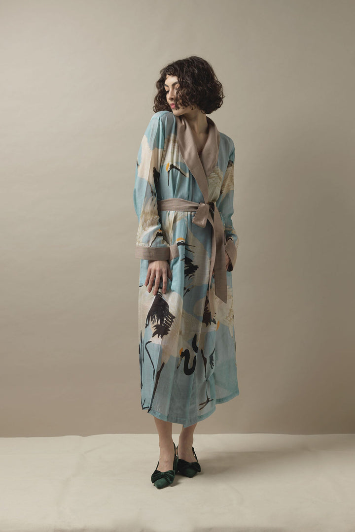 This lightweight design falls to an elegant long length and features a fold over collar, complete with self-tie waist belt and front patch pockets.