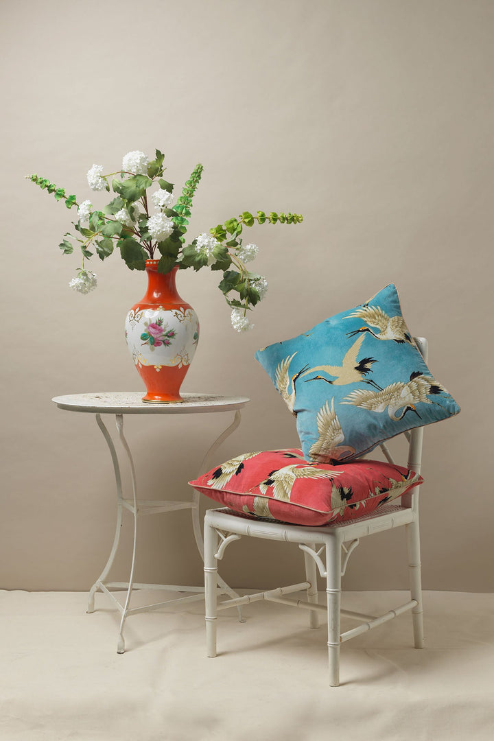 One Hundred Stars Stork Sky Blue Stork Crane Cushion featuring black and white cranes on a bright blue background. 